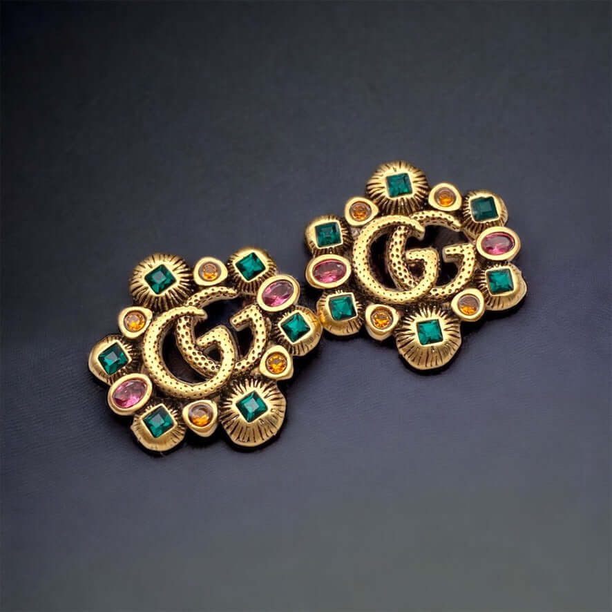 Gucci Stunning Antique Gold (ish) Tone with various colors & shapes crystals Post EarringsAdd some sparkle to your life with these Gucci Stunning Antique Gold (ish) Tone Post Earrings! Featuring the iconic Gucci Double G Marmont Line, these earrings are a