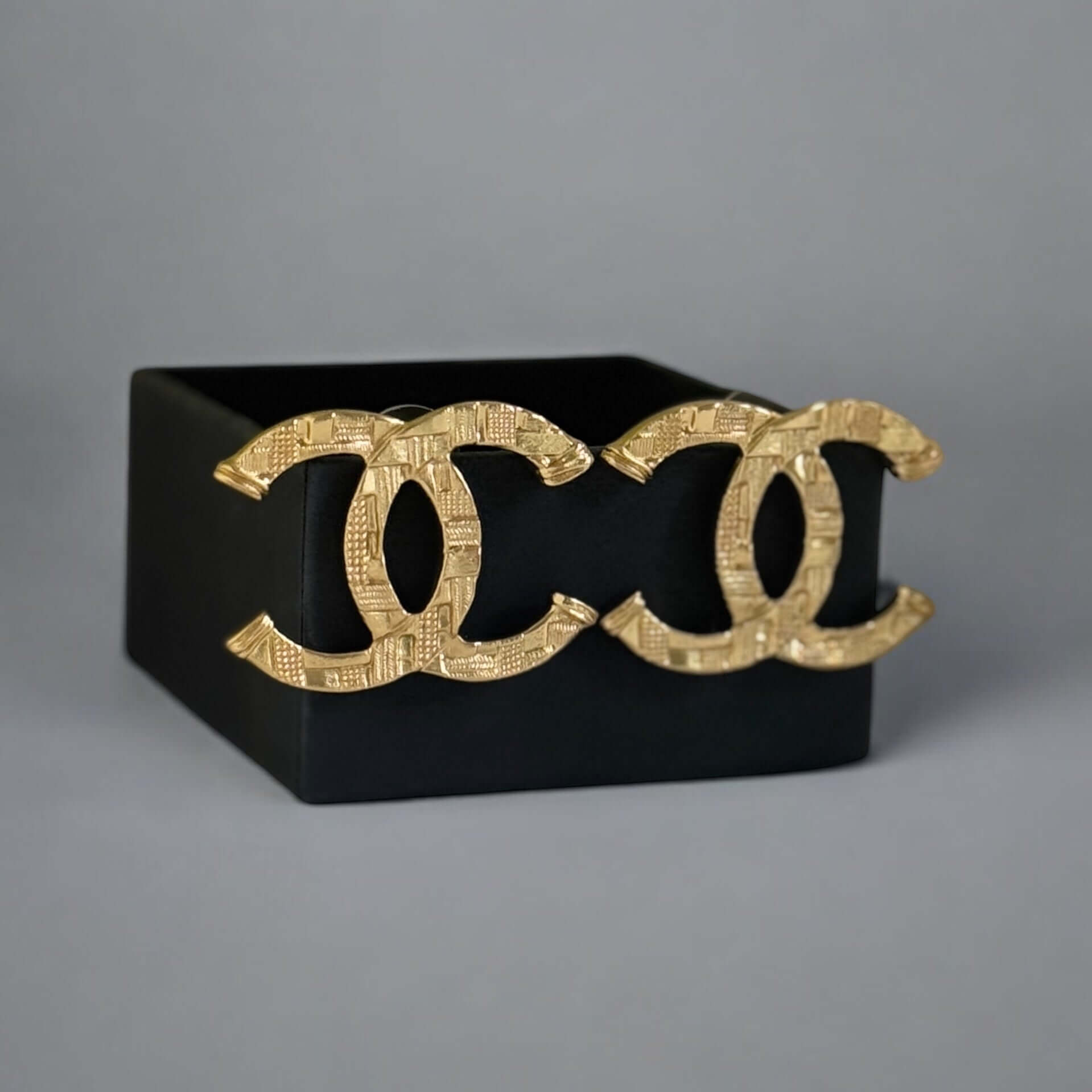 Authentic Chanel Gold Textured CC Pre-Owned Earrings in original box, showcasing bold yet minimalist design.