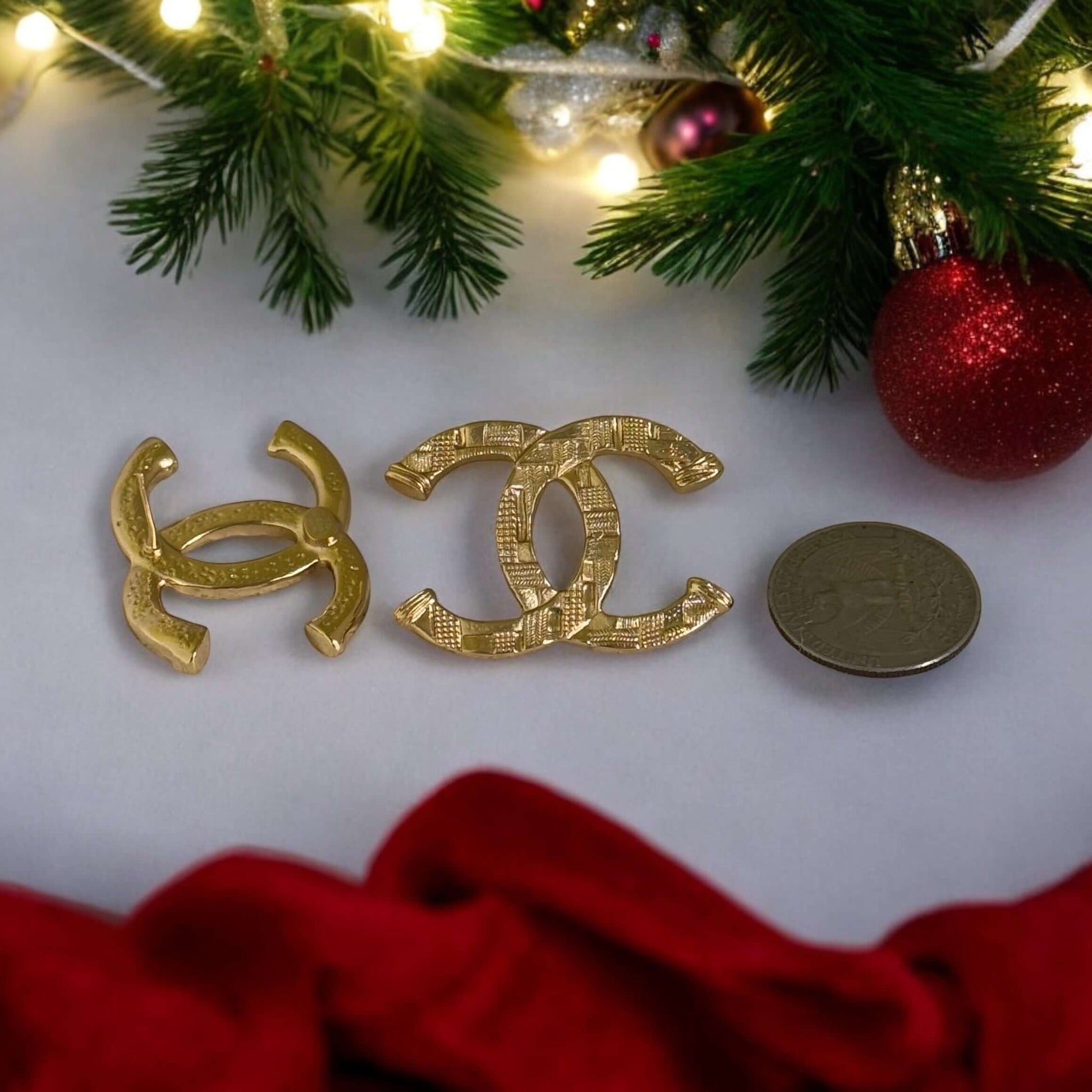 Authentic Chanel gold textured CC pre-owned earrings displayed with a coin for size reference, perfect for a bold statement.