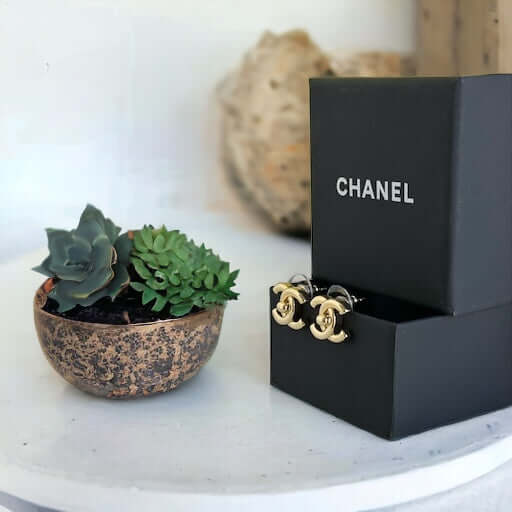 Chanel Gold Double C Lock Post EarringsIndulge in sophistication with our Chanel Gold Double C Lock Post Earrings. Crafted in 14K gold tone, these iconic and elegant earrings are the epitome of luxury. The double C lock style, made in Italy, adds a touch