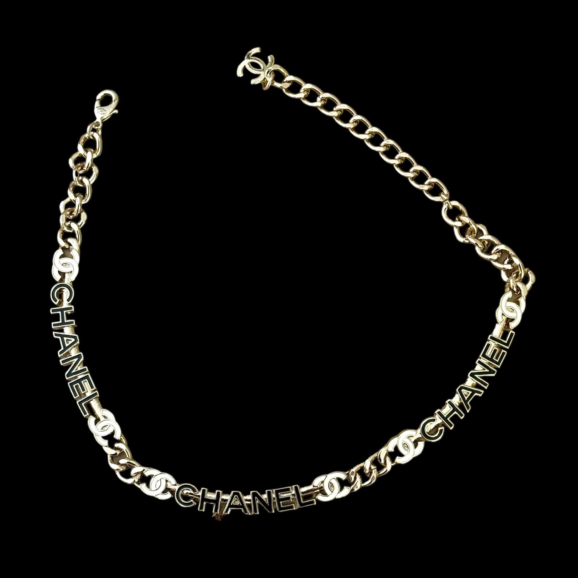 Chanel Strass Chain Adjustable Choker with black and white name pendants, gold chain, luxury floral details, perfect for any outfit.