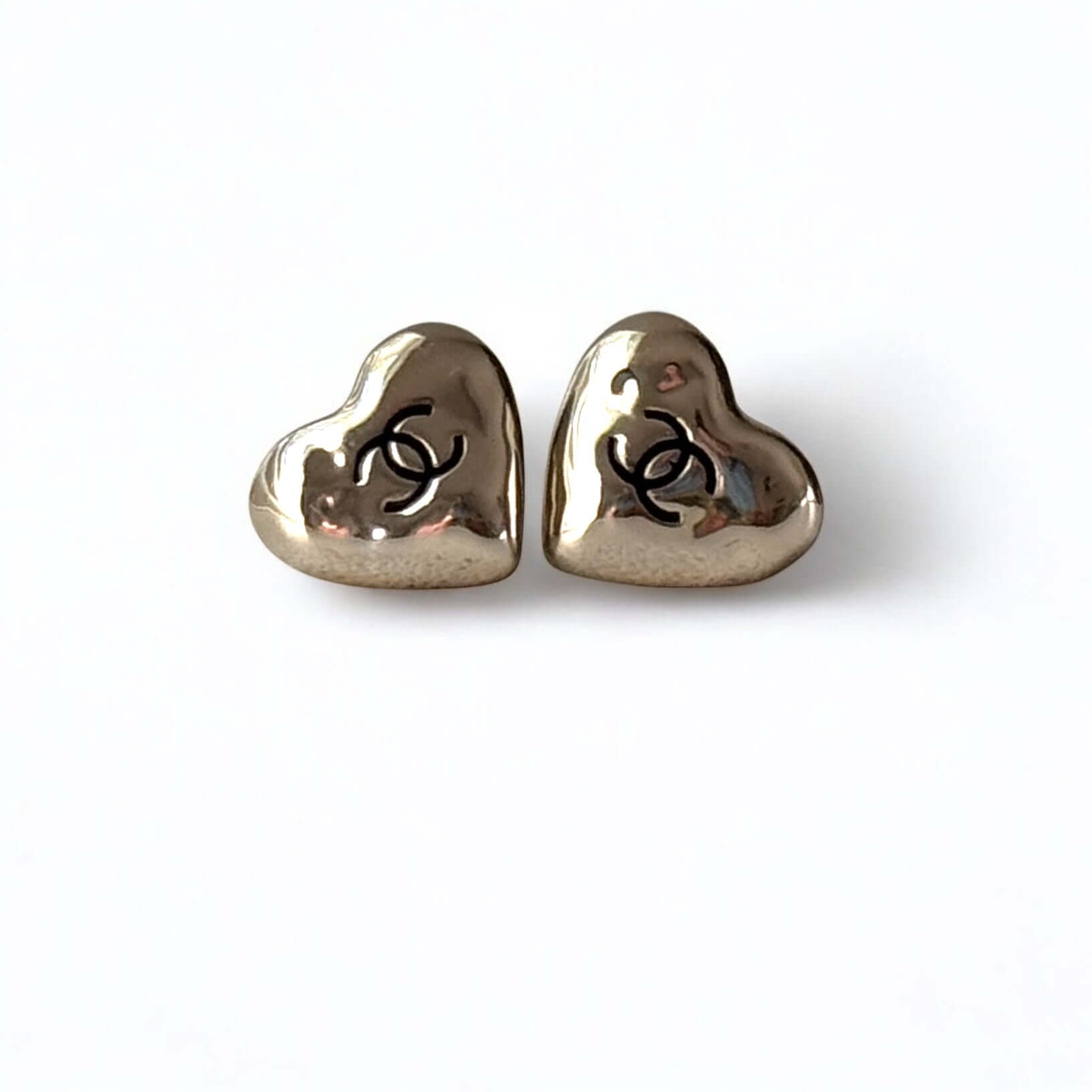 Authentic CHANEL gold plated puffy heart earrings featuring black enamel CC logo, pre-owned in excellent condition.