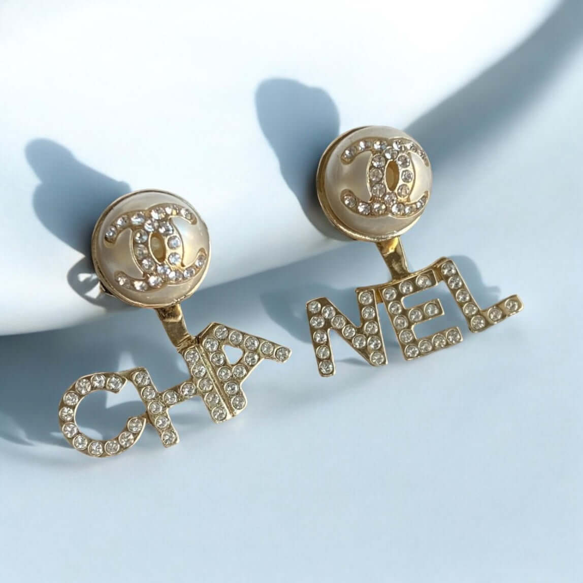 Chanel Gold CC Crystals Enamel Post Drop Earrings with "CHA" and "NEL" wording, pearl off white enamel, crystal encrusted, in great pre-owned condition