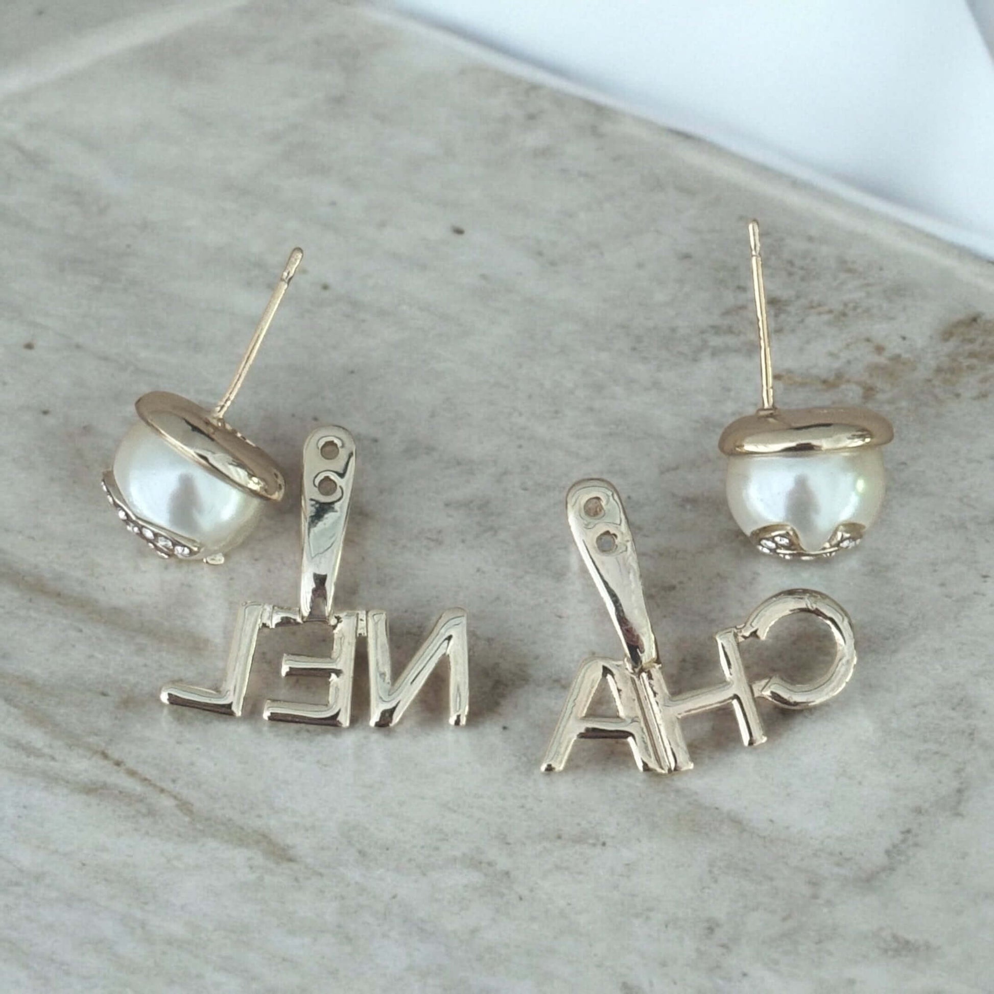 Chanel Gold CC Crystals Enamel Post Drop Earrings with Pearlish Off White Enamel on Marble Background