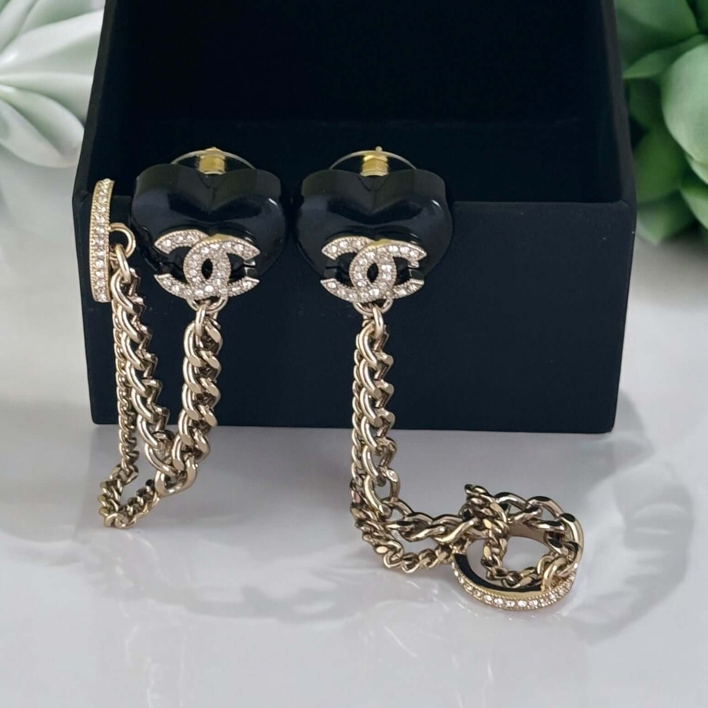 Chanel gold and black chain heart earrings with attached ear cuff in box, adorned with CC logo and crystals, perfect for a rockstar look