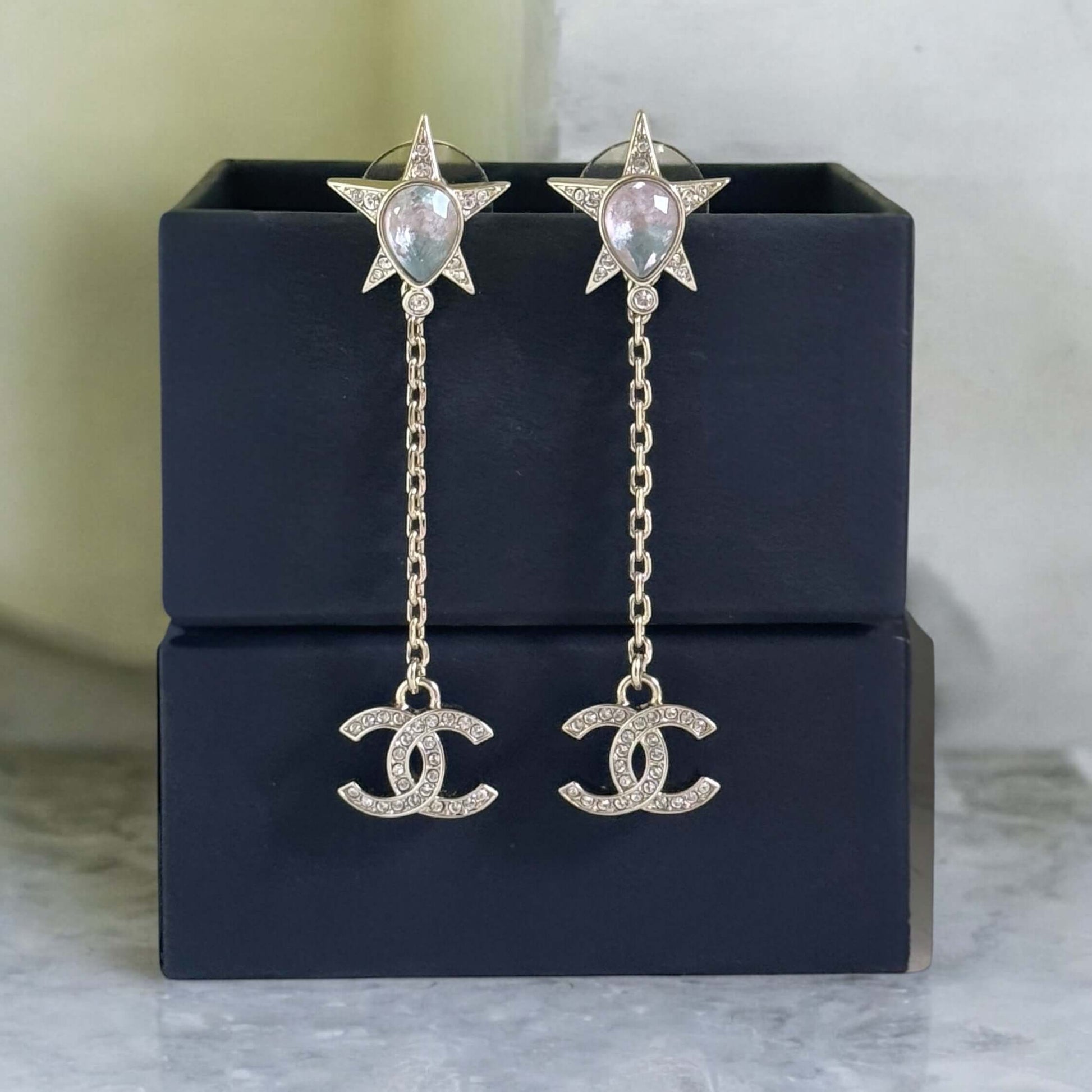 Gorgeous Authentic Chanel CC Star Dangle Earrings in like-new condition, featuring colorful crystals and chain drop design.