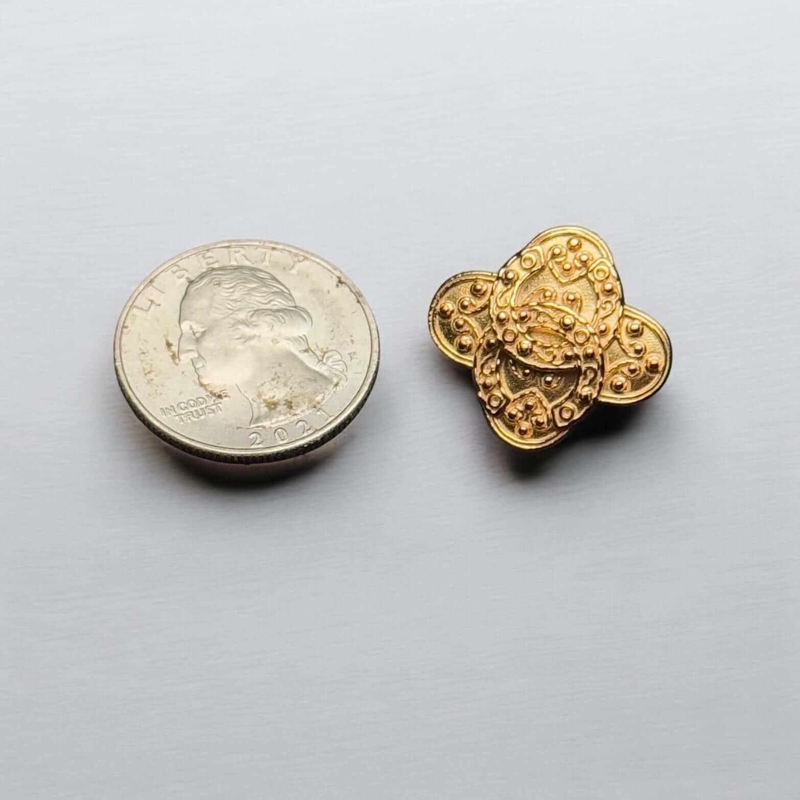 Vintage Chanel Gold Baroque CC Intricate Clip On Earring beside a quarter for size comparison.