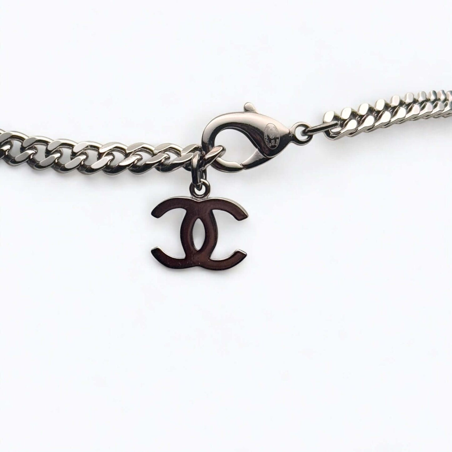 Authentic Chanel CC Choker with gun metal chain and elegant logo charm, in excellent pre-owned condition.