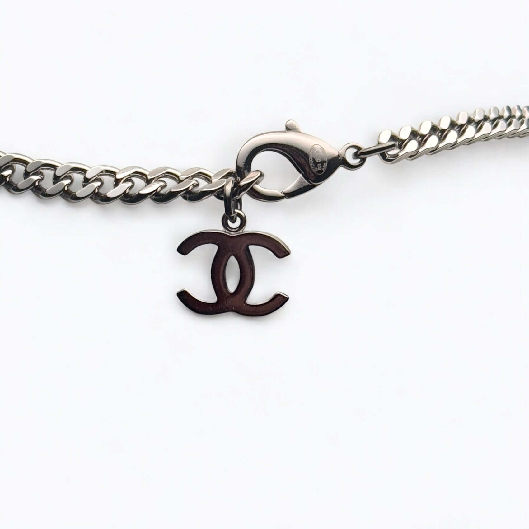 Authentic Chanel CC Choker with gun metal chain and elegant logo charm, in excellent pre-owned condition.