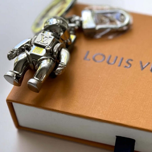 New Louis Vuitton Silver Astronaut Key Ring with Box ￼Upgrade your key game with this funky New Louis Vuitton Silver Astronaut Key Ring. Crafted from solid stainless steel, this rare and hard-to-find key chain features a playful astronaut design that is p