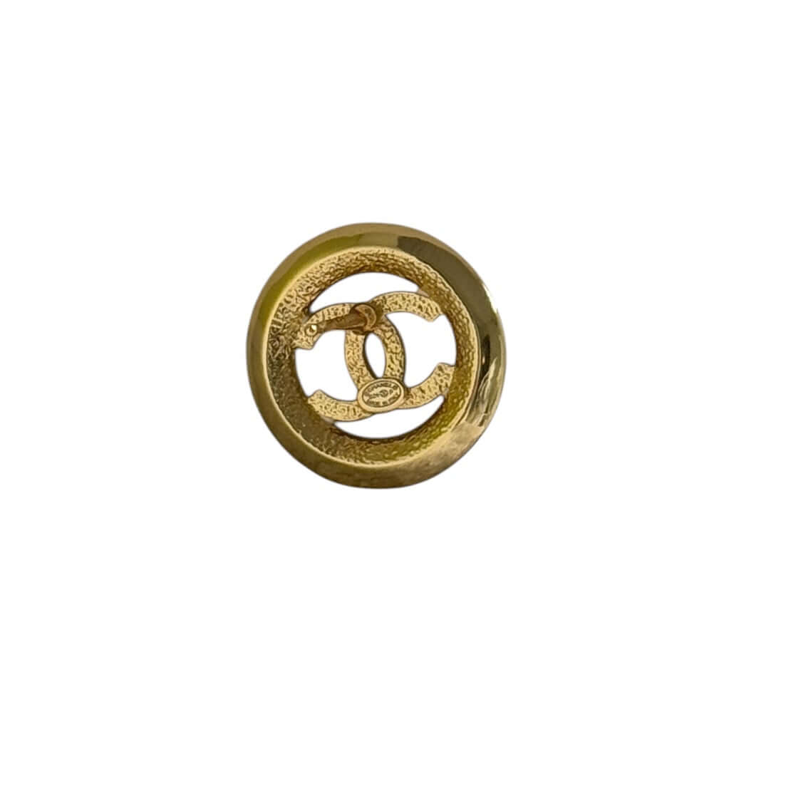 Chanel round cut out CC logo in gold, showcasing a sleek design and elegant craftsmanship. Perfect for any fashion lover.