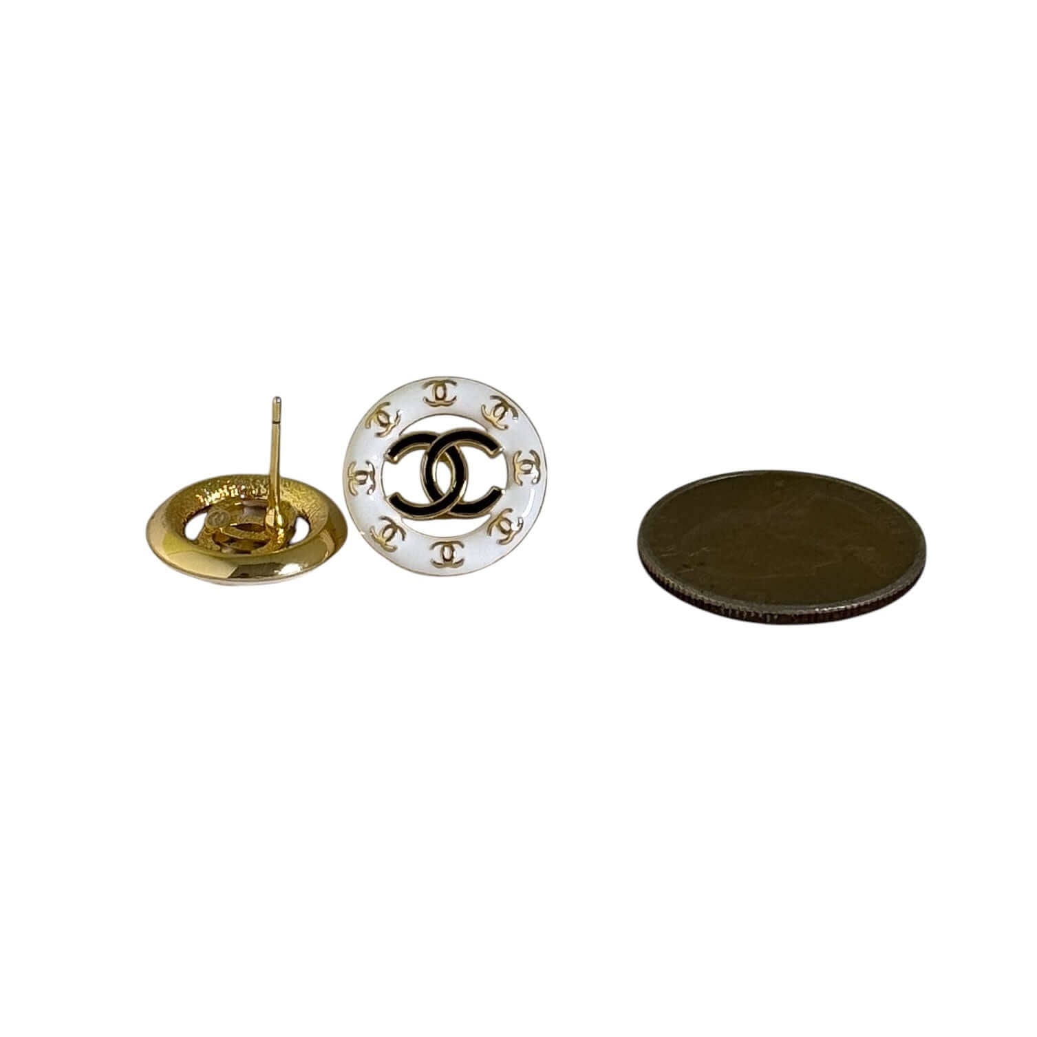 Pre-Owned Chanel Round Cut Out CC Gold White Black Earrings beside a coin for size comparison, showcasing the elegant logo design.