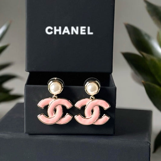 Chanel Lighter Gold Strass Pearl Post with Bigger Pink Enamel Double C Dangle EarringsAdd some playful CoCo Chanel style to your look with these gorgeous earrings! These earrings are a statement piece that will never go out of style. Made in Italy, they f