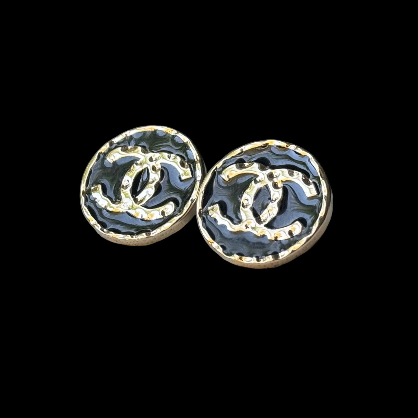 Chanel Gold Double C Textured Black Enamel Round Earrings 24 C Made in ItalyElevate any outfit with Chanel's iconic Gold Double C Textured Black Enamel Earrings. Made in Italy with a stunning minimal texture and smooth black enamel, these round post earri