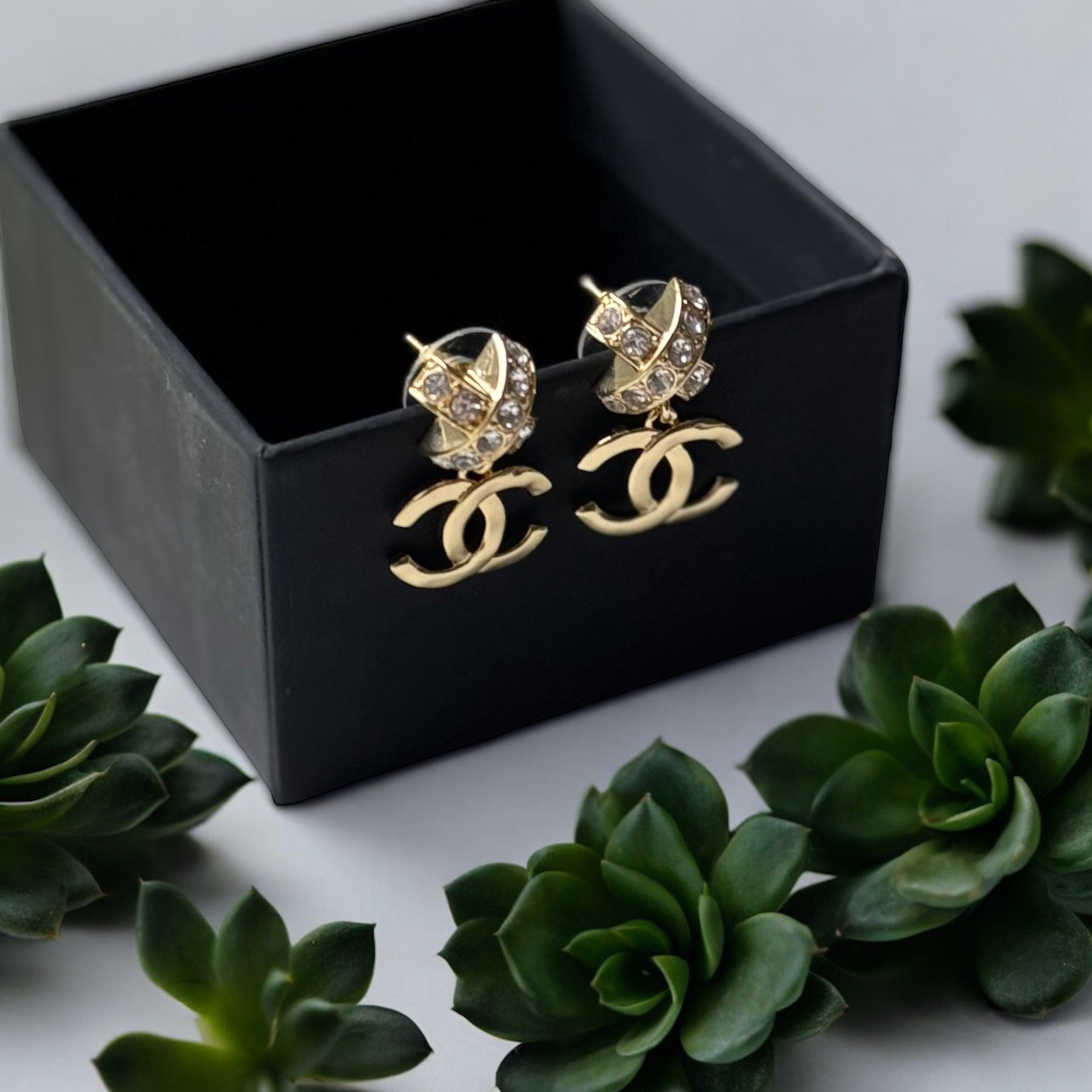 Chanel Gold Double C Dangle Earrings with Crystal Encrusted X’s Post EarringsAdd a touch of understated elegance to any outfit with Chanel's Gold Double C Dangle Earrings. Crystal encrusted X's add a statement touch to these comfortable post earrings. Per