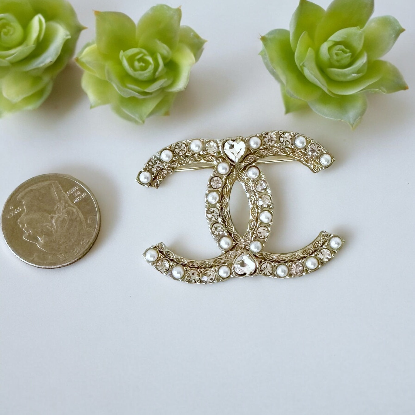 Chanel Paler Gold Double C Pearls Crystals Dressy BroochRare Style Like New Gorgeous Chanel Paler Gold Double C Pearls & Crystals Has a heart like shaped crystal in the center of both top and bottom . Faux Pearls Clear Crystals Strass Gold Plated Comes wi