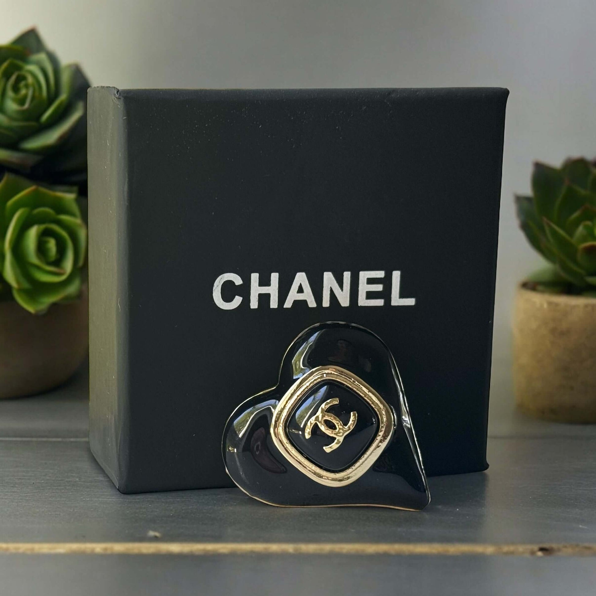 Chanel Gold Plated with Smooth Black Enamel Double C accents Heart Shaped Brooch PinAdd a touch of playful glam with this Chanel Gold Plated Heart Shaped Brooch. Featuring a sleek black enamel design and updated double C logo, this brooch is in like-new c