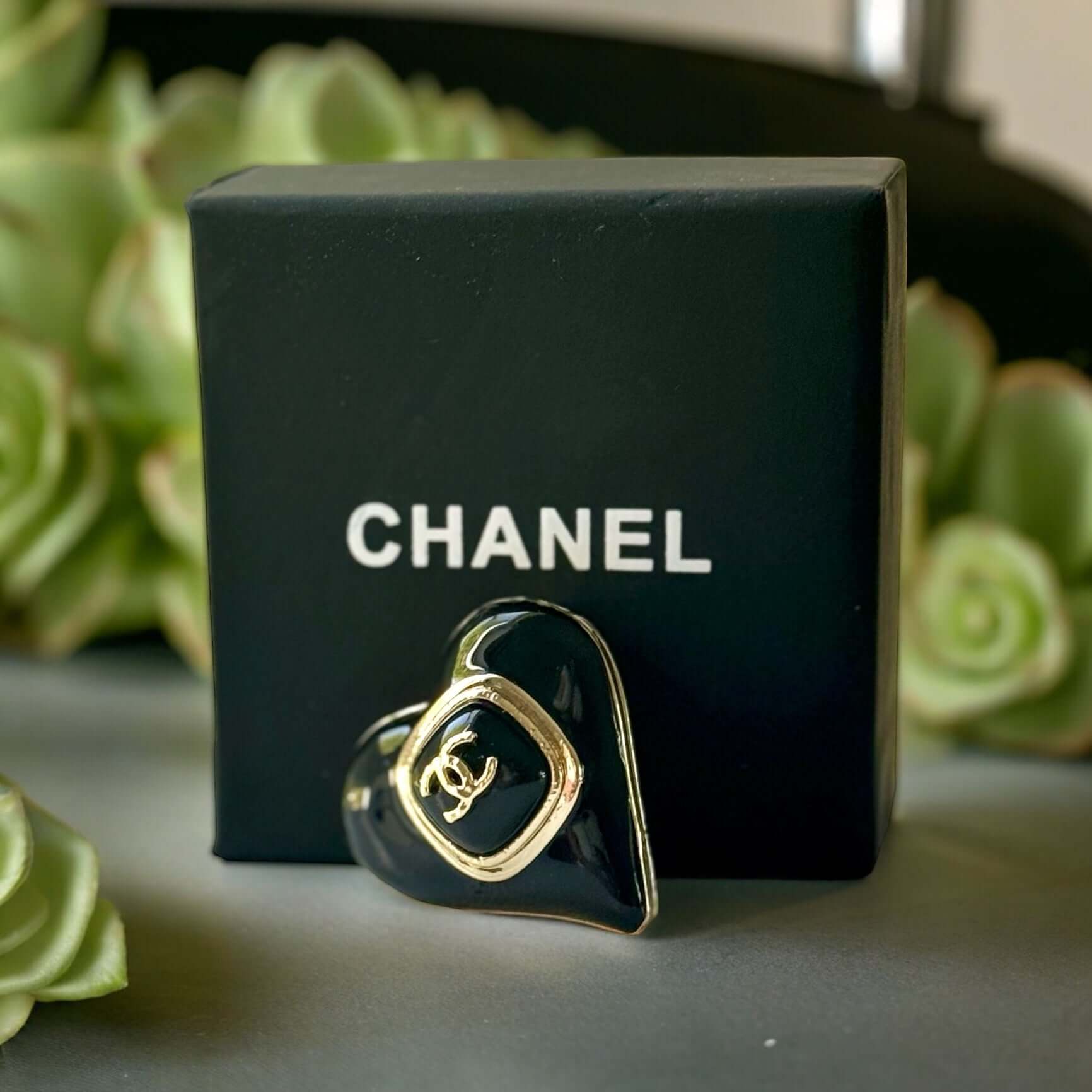 Chanel Gold Plated with Smooth Black Enamel Double C accents Heart Shaped Brooch PinAdd a touch of playful glam with this Chanel Gold Plated Heart Shaped Brooch. Featuring a sleek black enamel design and updated double C logo, this brooch is in like-new c