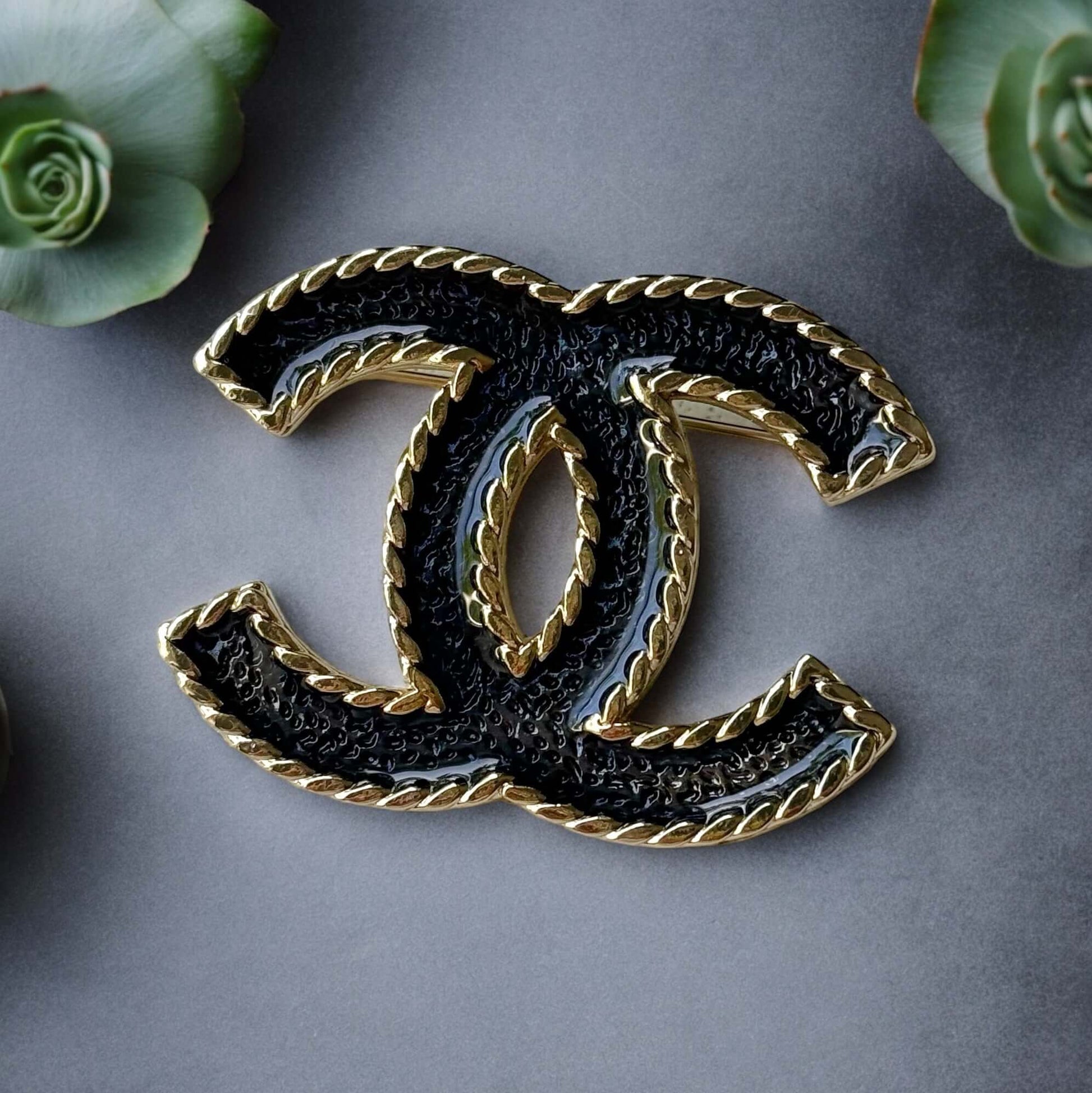 Chanel Lighter Gold Double C with Blue Denim Enamel Brooch Pin S24Experience the luxurious elegance of Chanel with our Lighter Gold Double C Brooch. This stunning brooch features a trendy denim blue enamel design and is ageless, making it perfect for any