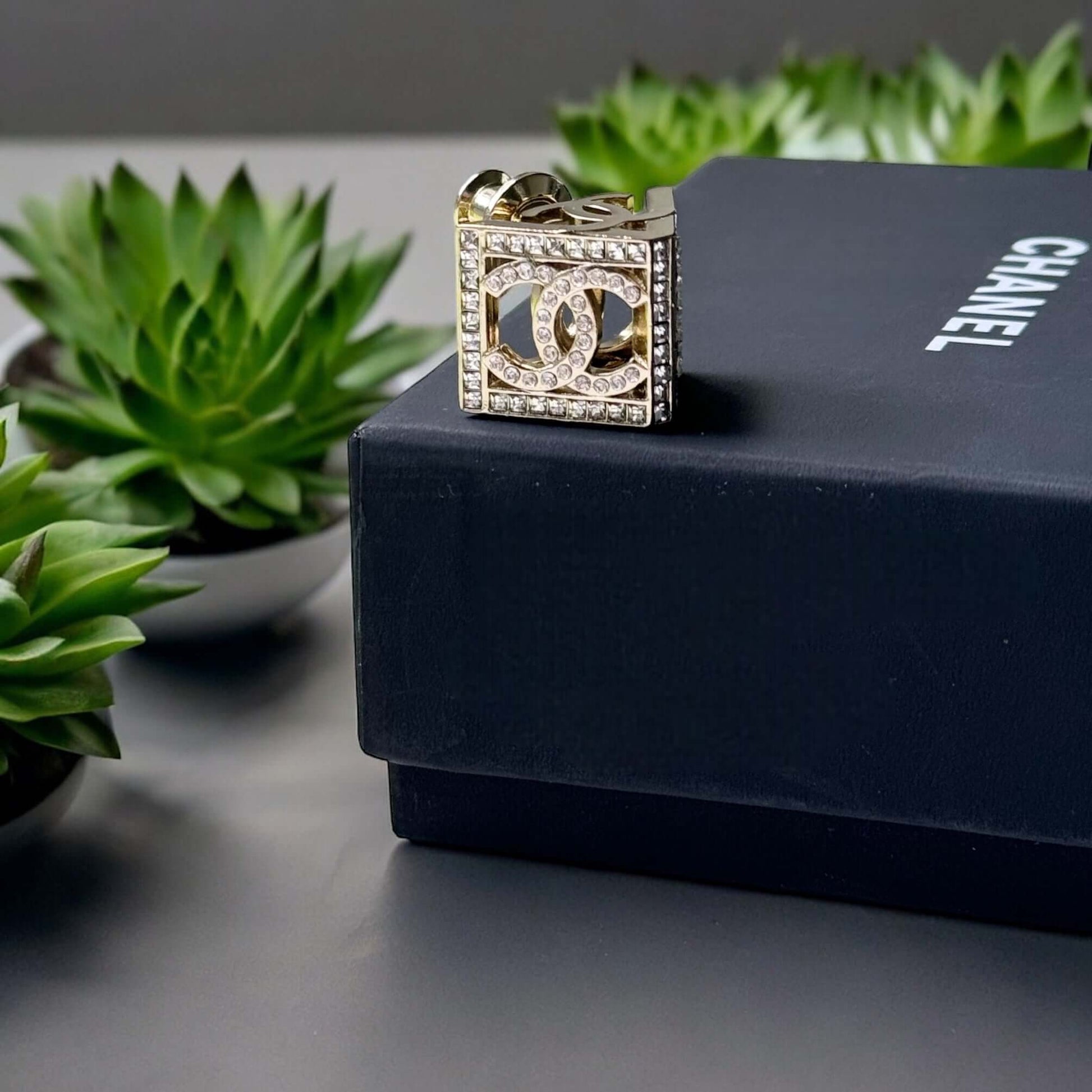 Chanel Lighter Gold Double C with Crystals Triangle Styled Smaller Brooch PinSet your style on fire with the Chanel Lighter Gold Double C brooch pin. Covered in dazzling crystals, this triangular piece adds a touch of bling to any outfit. Playfully chic,