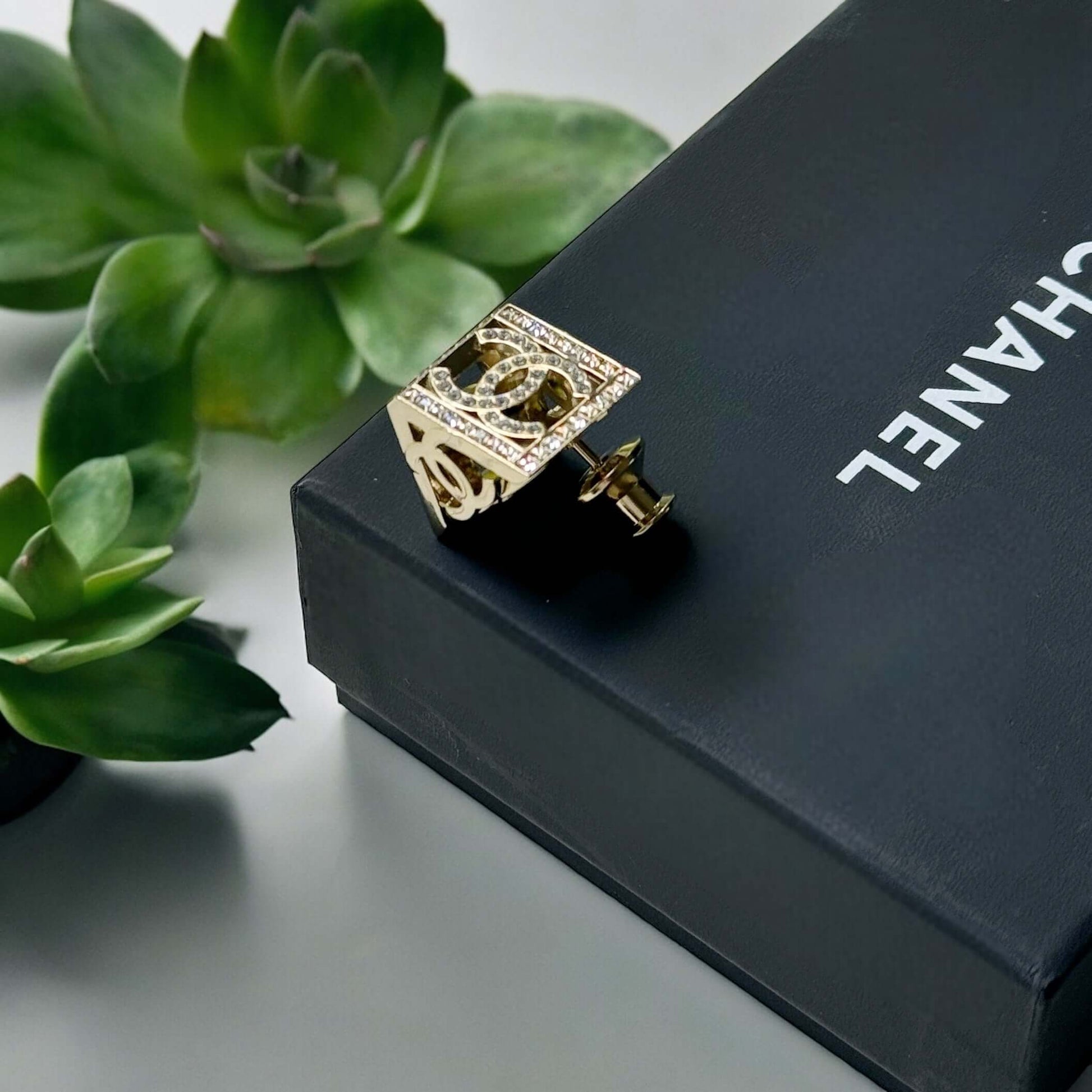 Chanel Lighter Gold Double C with Crystals Triangle Styled Smaller Brooch PinSet your style on fire with the Chanel Lighter Gold Double C brooch pin. Covered in dazzling crystals, this triangular piece adds a touch of bling to any outfit. Playfully chic,