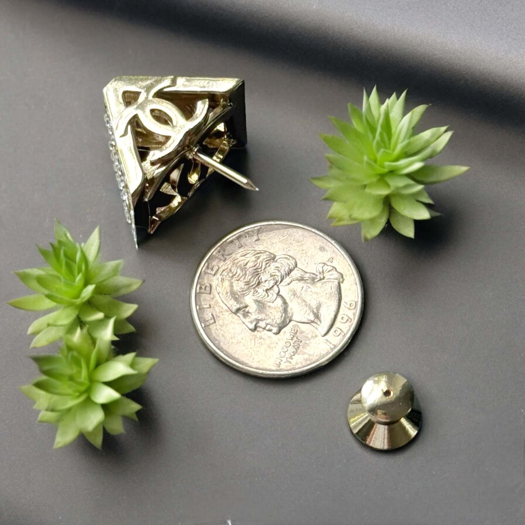 Chanel Lighter Gold Double C with Crystals Triangle Styled Smaller Brooch PinSet your style on fire with the Chanel Lighter Gold Double C brooch pin. Covered in dazzling crystals, this triangular piece adds a touch of bling to any outfit. Playfully chic,
