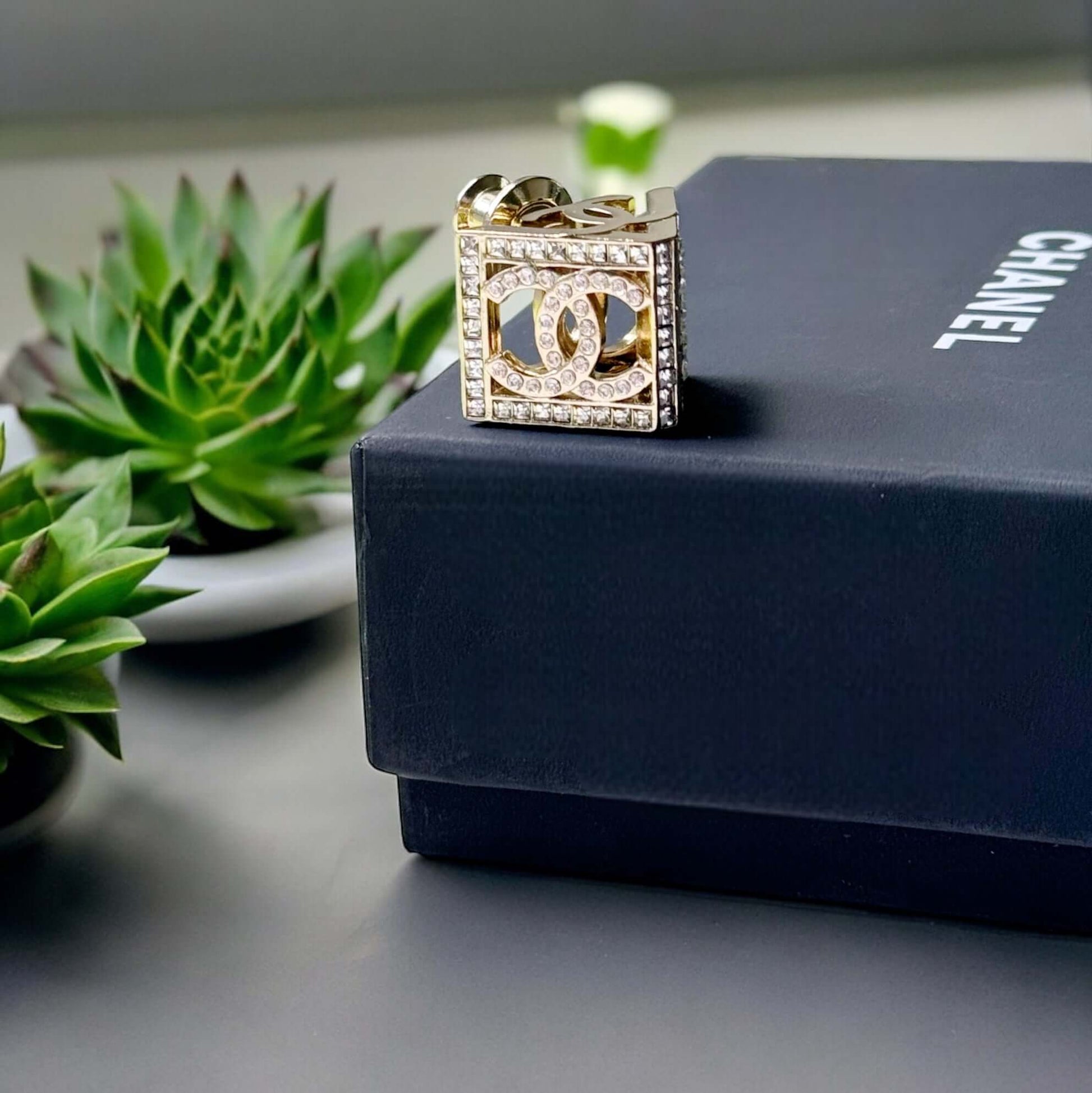 Chanel Lighter Gold Double C with Crystals Triangle Styled Smaller Brooch PinSet your style on fire with the Chanel Lighter Gold Double C brooch pin. Covered in dazzling crystals, this triangular piece adds a touch of bling to any outfit. Playfully chic,