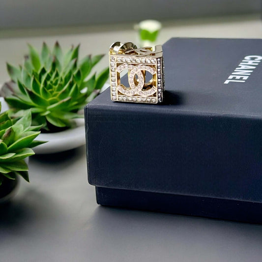 Chanel Lighter Gold Double C with Crystals Triangle Styled Smaller Brooch PinSet your style on fire with the Chanel Lighter Gold Double C brooch pin. Covered in dazzling crystals, this triangular piece adds a touch of bling to any outfit. Playfully chic,