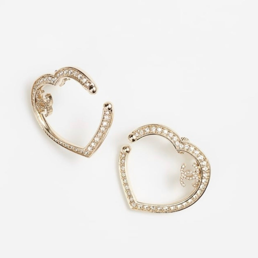 Chanel Gold Plated Big Cut Out Heart with Crystals Clip On EarringsGold Chanel Big Cut Out Heart Earrings with smaller clear crystals along the edges Purchased at an Estate Sale - The woman was an avid collector of high-end luxury designer jewelry , acces