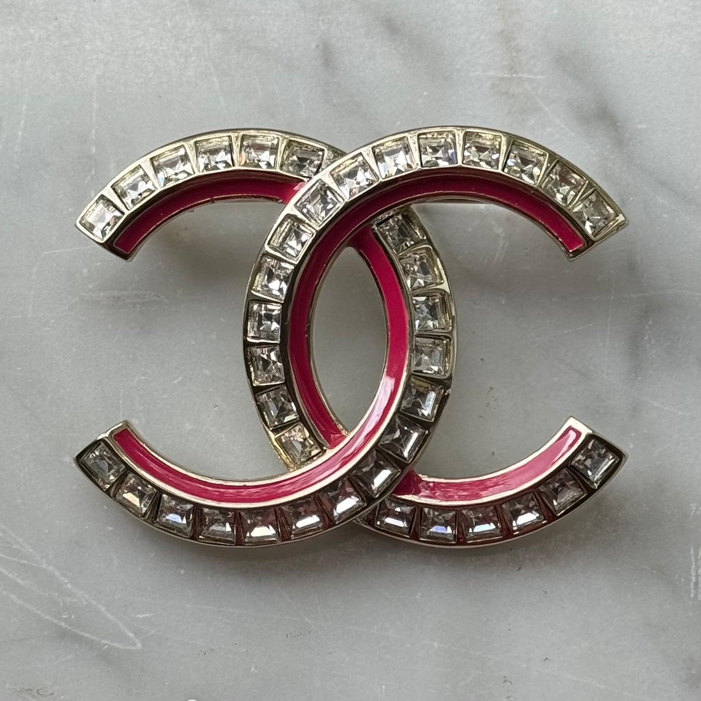 Chanel Gold Pink Enamel with Clear Crystals S24 Brooch PinTruly stunning On consignment Chanel Double C with square clear cut crystals and Pink Enamel Brooch Pin Clear Logo on the back Comes with the original Chanel Box & Bag Gift Giving Condition Free fr