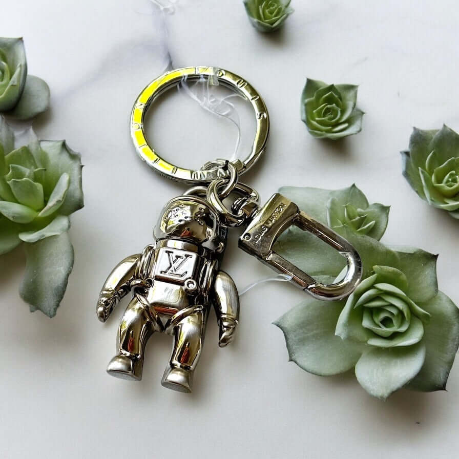 New Louis Vuitton Silver Astronaut Key Ring with Box ￼Upgrade your key game with this funky New Louis Vuitton Silver Astronaut Key Ring. Crafted from solid stainless steel, this rare and hard-to-find key chain features a playful astronaut design that is p My Mama Found What 