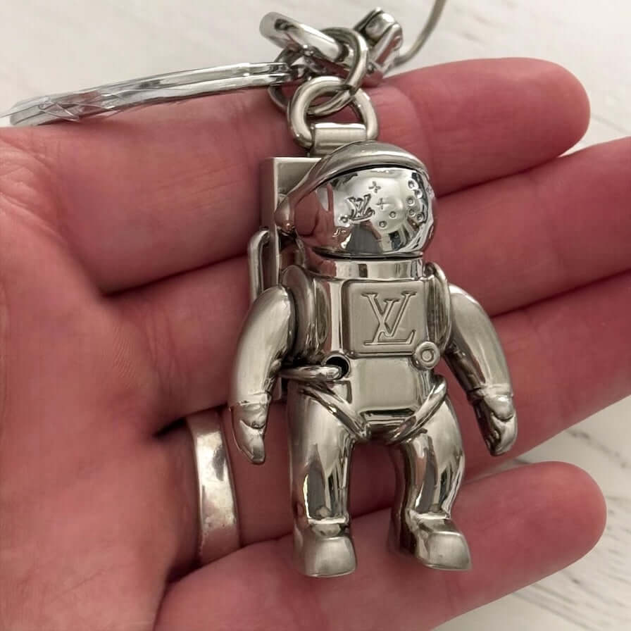 New Louis Vuitton Silver Astronaut Key Ring with Box ￼Upgrade your key game with this funky New Louis Vuitton Silver Astronaut Key Ring. Crafted from solid stainless steel, this rare and hard-to-find key chain features a playful astronaut design that is p My Mama Found What 