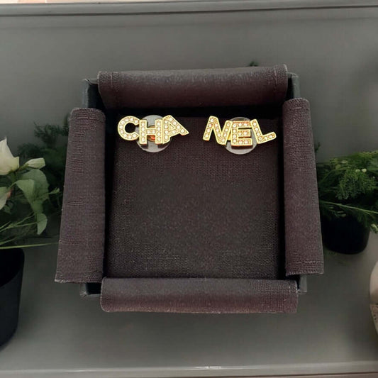 Chanel 14K Gold Name Cut-Out w/ clear crystals earringsAdd a touch of elegance and playfulness to your outfit with these Chanel 14K Gold Cut-Out Name earrings. The clear crystals add a subtle sparkle, making them perfect for any occasion. Their smaller si My Mama Found What 