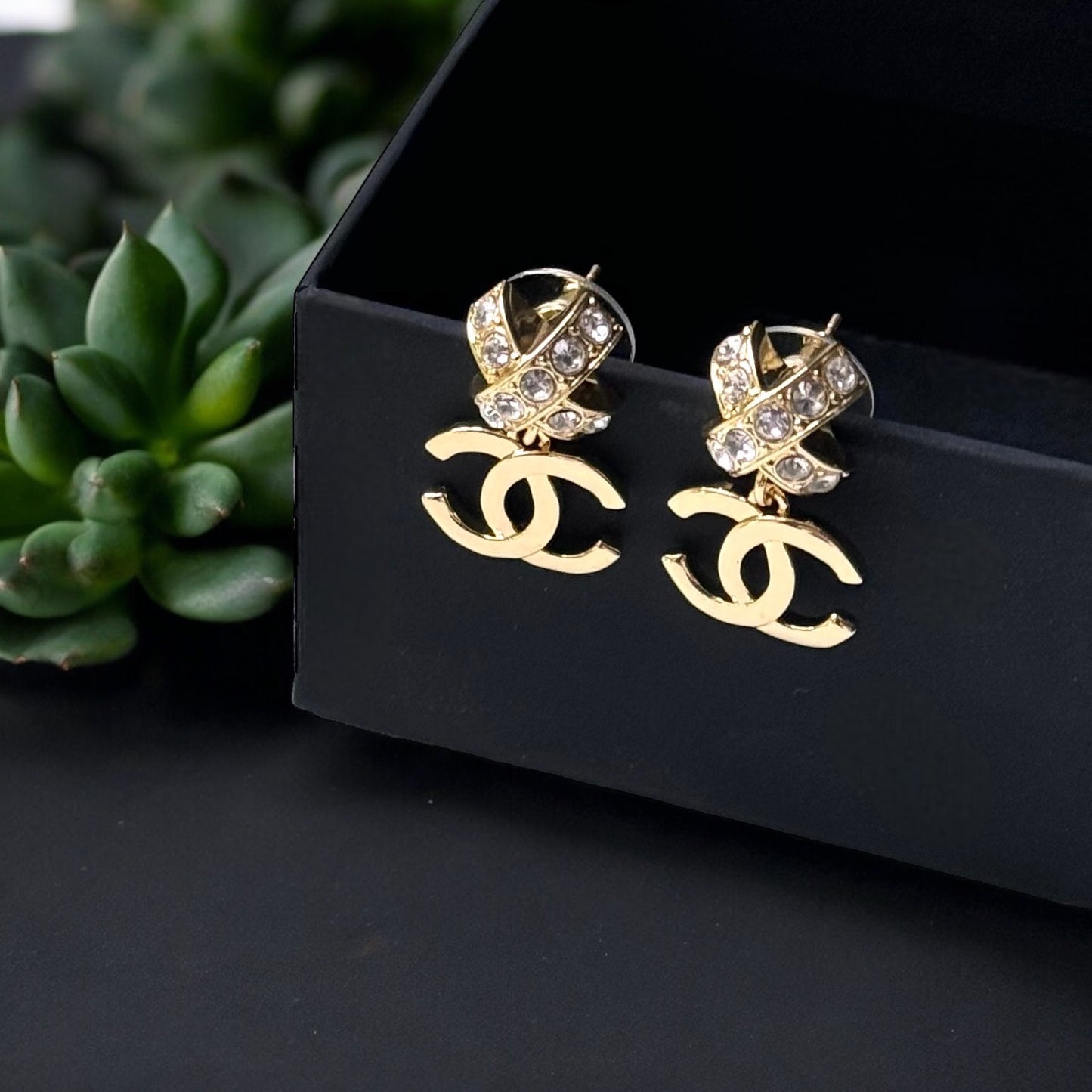 Chanel Gold Double C Dangle Earrings with Crystal Encrusted X’s Post EarringsAdd a touch of understated elegance to any outfit with Chanel's Gold Double C Dangle Earrings. Crystal encrusted X's add a statement touch to these comfortable post earrings. Per My Mama Found What 