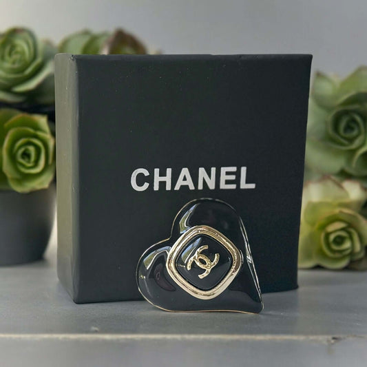 Chanel Gold Plated with Smooth Black Enamel Double C accents Heart Shaped Brooch PinAdd a touch of playful glam with this Chanel Gold Plated Heart Shaped Brooch. Featuring a sleek black enamel design and updated double C logo, this brooch is in like-new c My Mama Found What 