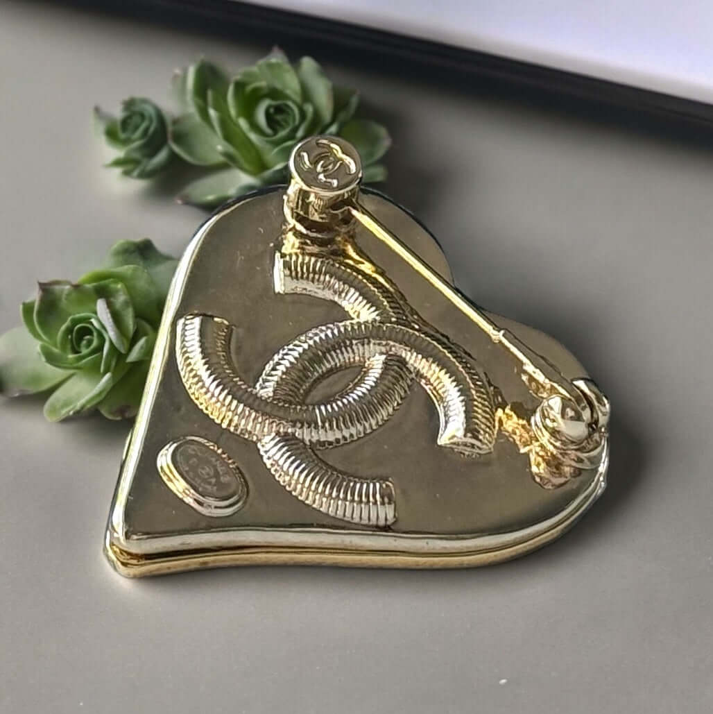 Chanel Gold Plated with Smooth Black Enamel Double C accents Heart Shaped Brooch PinAdd a touch of playful glam with this Chanel Gold Plated Heart Shaped Brooch. Featuring a sleek black enamel design and updated double C logo, this brooch is in like-new c My Mama Found What 