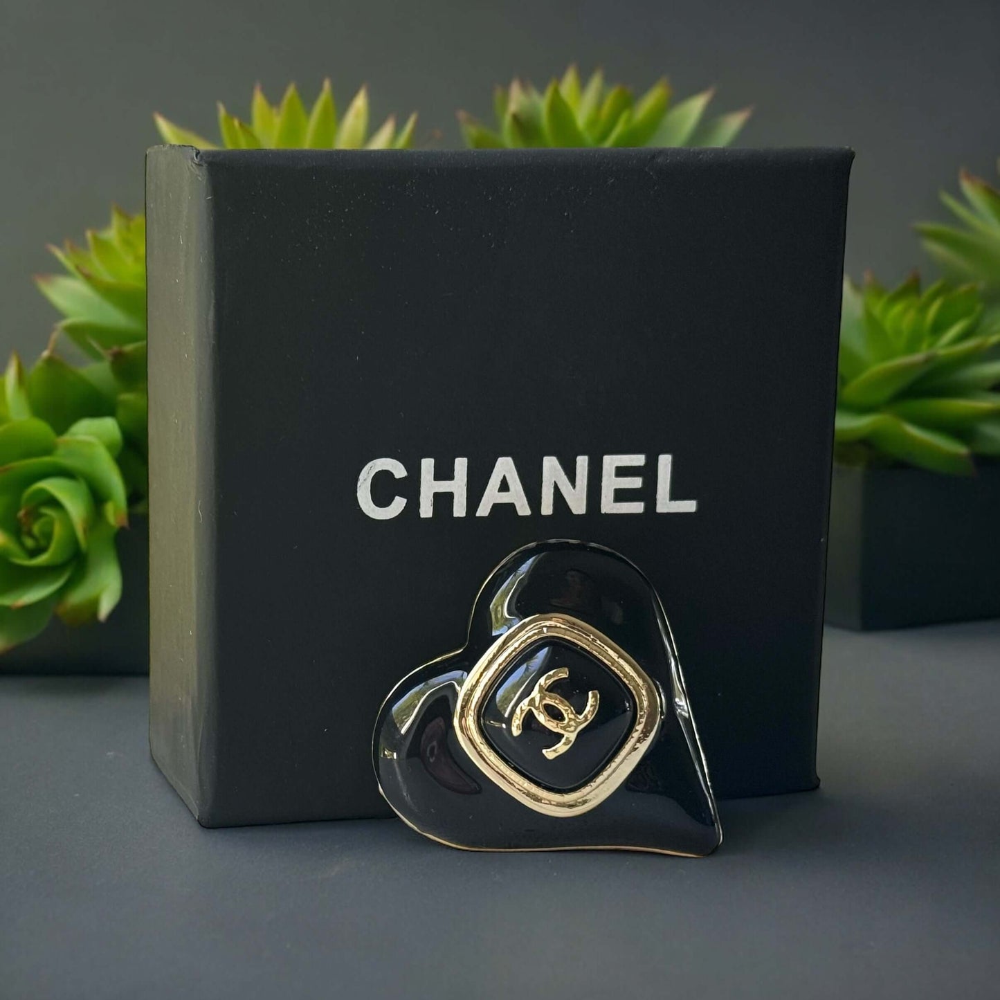 Chanel Gold Plated with Smooth Black Enamel Double C accents Heart Shaped Brooch PinAdd a touch of playful glam with this Chanel Gold Plated Heart Shaped Brooch. Featuring a sleek black enamel design and updated double C logo, this brooch is in like-new c My Mama Found What 