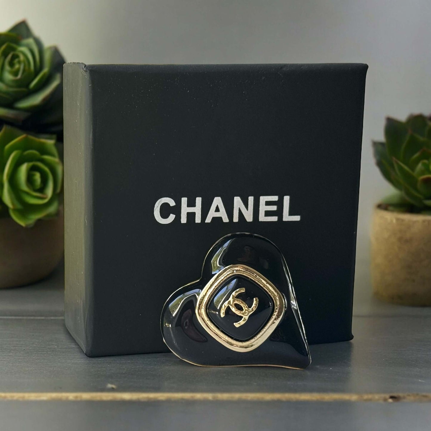 Chanel Gold Plated with Smooth Black Enamel Double C accents Heart Shaped Brooch PinAdd a touch of playful glam with this Chanel Gold Plated Heart Shaped Brooch. Featuring a sleek black enamel design and updated double C logo, this brooch is in like-new c My Mama Found What 